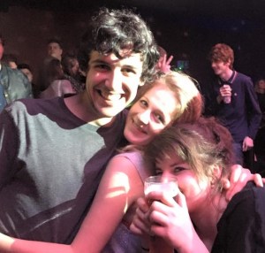 Roo and friends in a nightclub, hugging and laughing